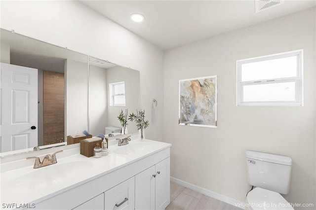 bathroom featuring toilet and vanity