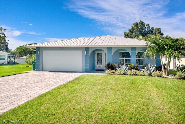 single story home with an attached garage, a front lawn, decorative driveway, and stucco siding