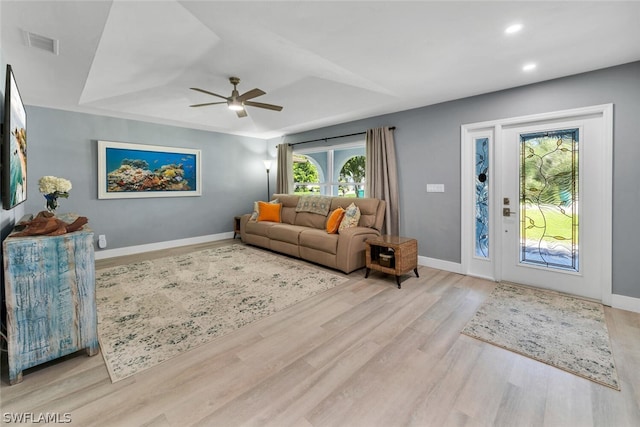 living room with baseboards, visible vents, ceiling fan, light wood-type flooring, and recessed lighting