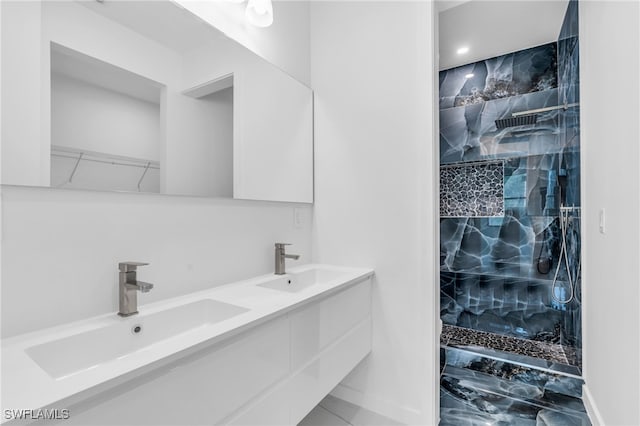 bathroom featuring vanity and tiled shower