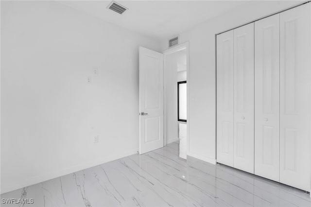 unfurnished bedroom with a closet