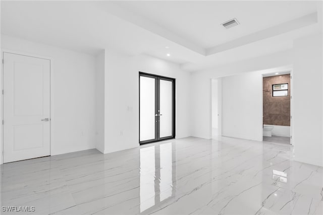 unfurnished room featuring french doors