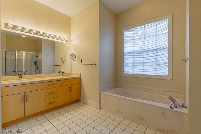 bathroom featuring independent shower and bath, tile patterned floors, and dual bowl vanity