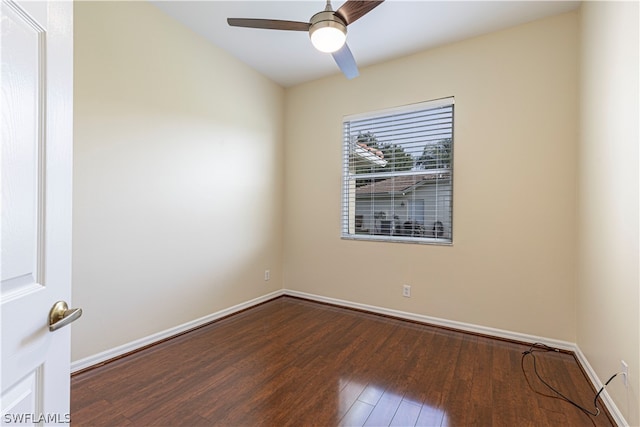 spare room with ceiling fan and dark wood-type flooring