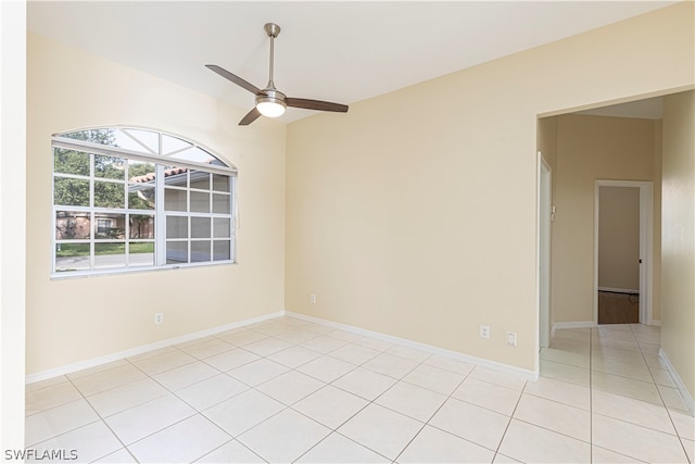 tiled spare room with ceiling fan