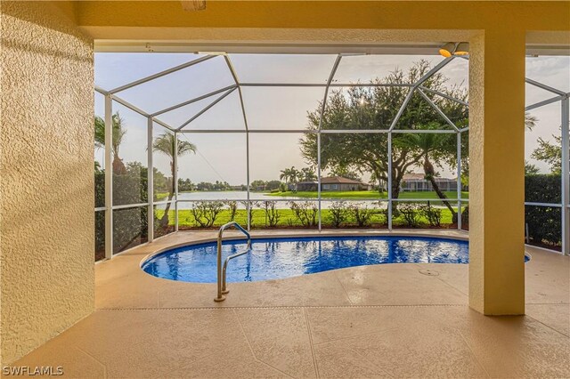 view of pool with a patio and glass enclosure