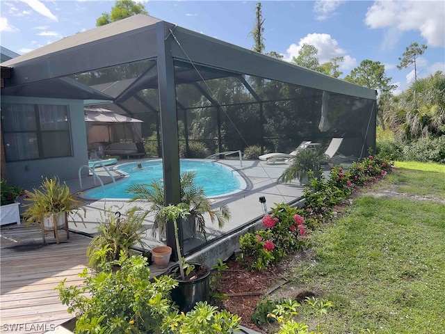 view of swimming pool with a lanai