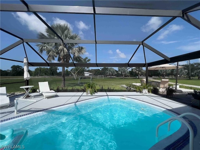 pool with glass enclosure, a patio, and a yard