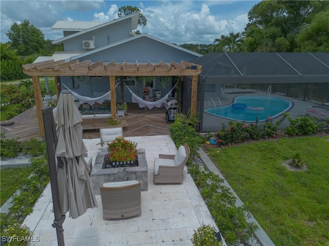 exterior space featuring a patio area, glass enclosure, an outdoor pool, and a yard