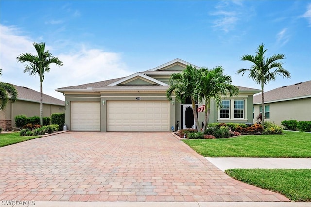 ranch-style house featuring a front lawn and a garage