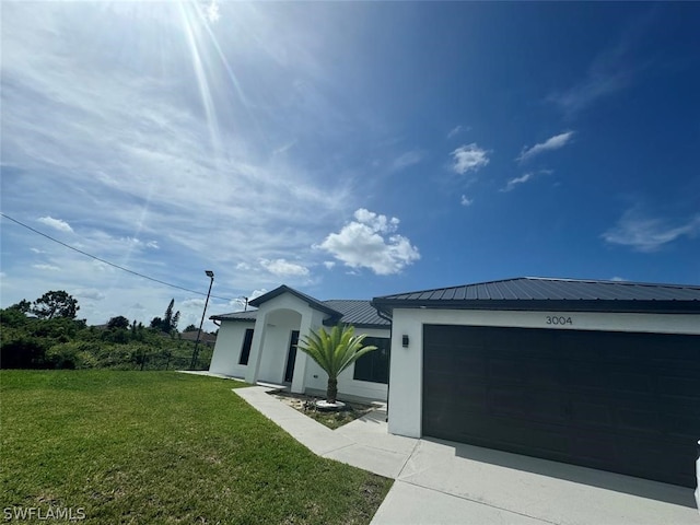 view of property exterior with a garage and a lawn