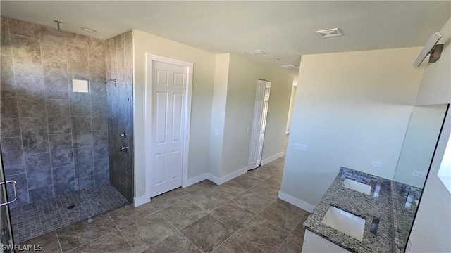 bathroom with tile patterned floors, vanity, and a shower with shower door