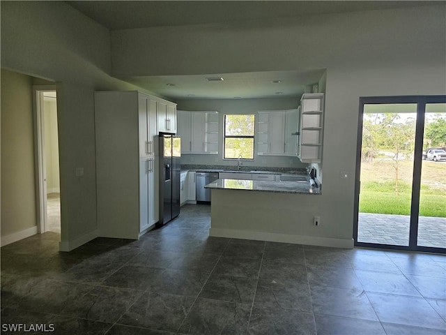 kitchen with fridge with ice dispenser, light stone countertops, white cabinetry, stainless steel dishwasher, and kitchen peninsula