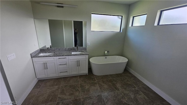 bathroom with vanity and a tub to relax in