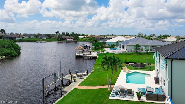 exterior space featuring a patio, a yard, an outdoor living space, a water view, and a dock