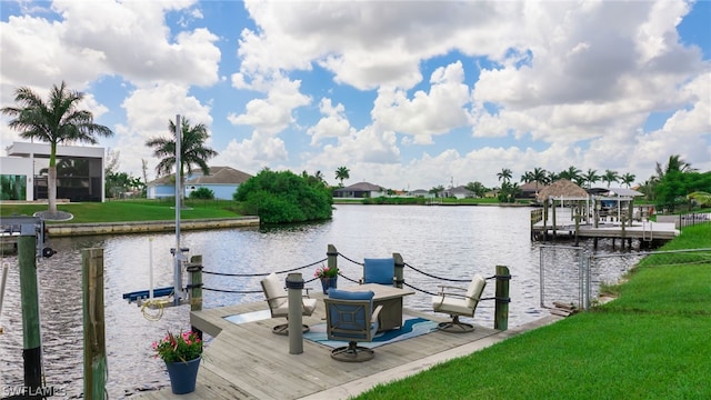 view of dock with a water view and a lawn