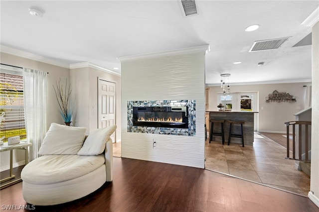 living area featuring crown molding and wood-type flooring