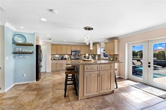 kitchen featuring decorative light fixtures, light brown cabinets, appliances with stainless steel finishes, a kitchen island, and decorative backsplash