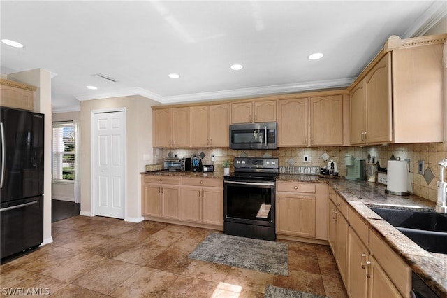 kitchen featuring electric range oven, light brown cabinetry, sink, backsplash, and black fridge