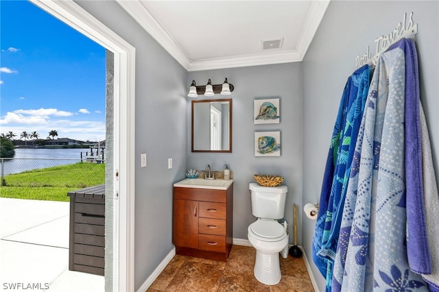 bathroom with a water view, ornamental molding, toilet, and vanity