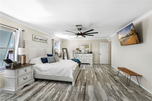 bedroom with ornamental molding, ceiling fan, and light hardwood / wood-style floors