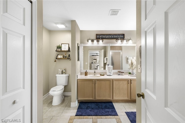 bathroom with vanity, tile patterned floors, and toilet