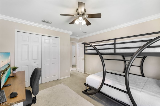 bedroom with light carpet, ornamental molding, a closet, and ceiling fan