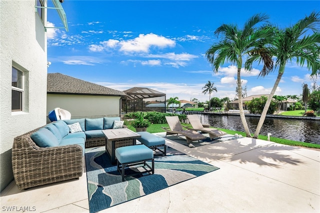 view of patio featuring a water view, outdoor lounge area, and glass enclosure