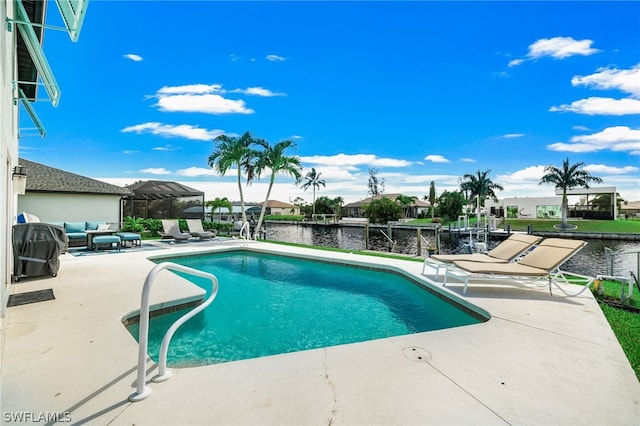 view of swimming pool featuring grilling area, a patio, and a water view