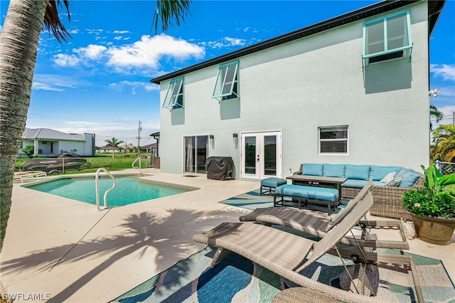 rear view of house with an outdoor living space, a patio area, and french doors