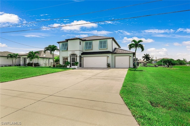 view of front of home with a front yard and a garage