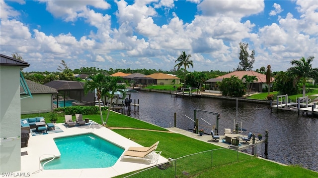 view of swimming pool with a patio, a lawn, a lanai, a water view, and a dock