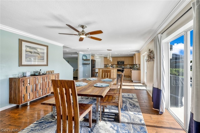 dining area with hardwood / wood-style flooring, ornamental molding, a textured ceiling, and ceiling fan