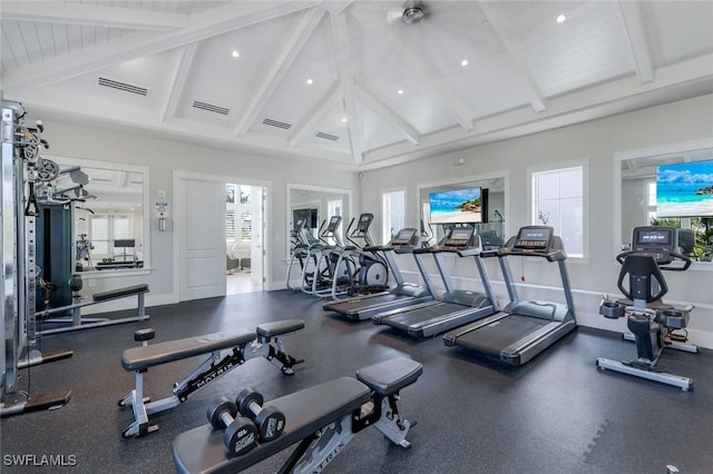 workout area with high vaulted ceiling, visible vents, and baseboards