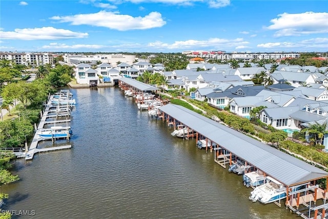 drone / aerial view with a water view and a residential view