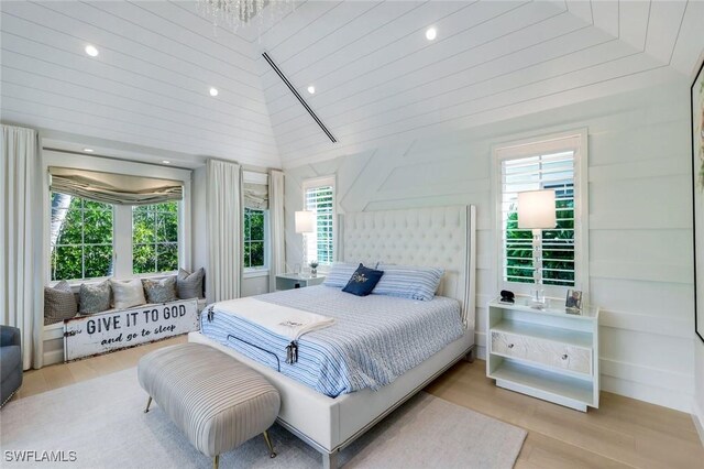 bedroom with recessed lighting, vaulted ceiling, and wood finished floors