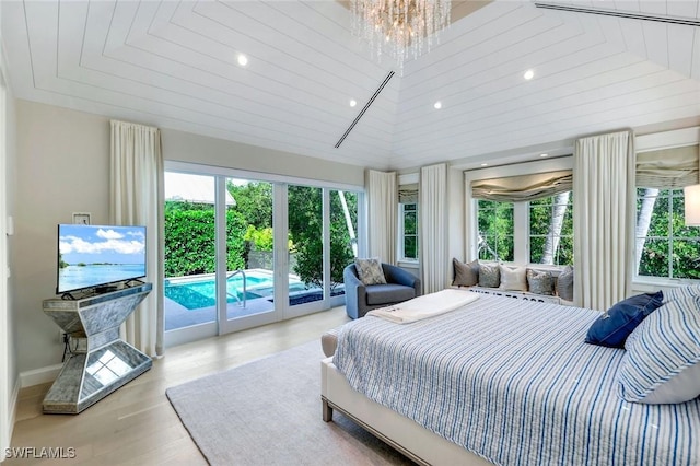 bedroom featuring access to outside, vaulted ceiling, recessed lighting, and wood finished floors