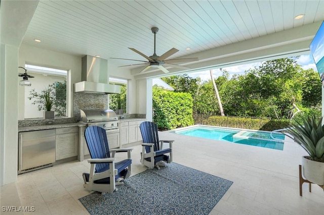 view of pool with a patio, an outdoor kitchen, area for grilling, a ceiling fan, and a pool with connected hot tub