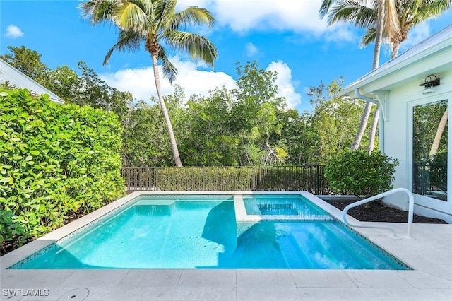 view of pool with a pool with connected hot tub and a fenced backyard