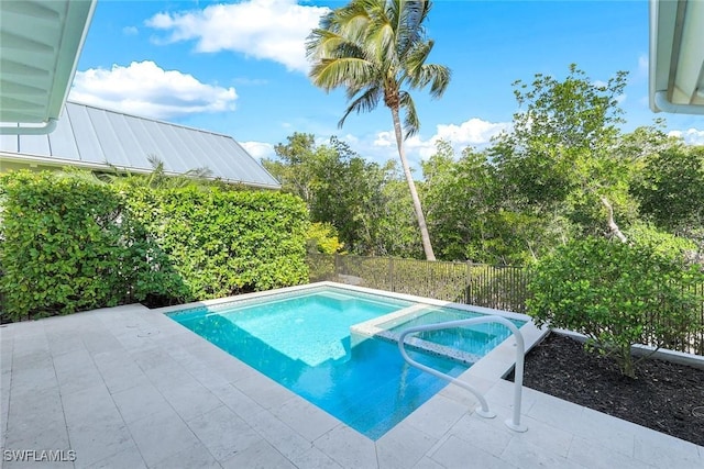 view of swimming pool with a pool with connected hot tub, a fenced backyard, and a patio