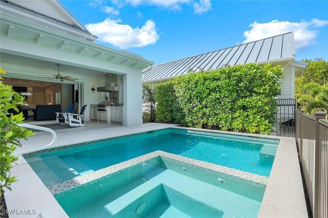 view of pool featuring a patio, a pool with connected hot tub, an outdoor kitchen, a grill, and ceiling fan