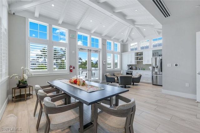 sunroom / solarium with french doors, visible vents, and vaulted ceiling with beams