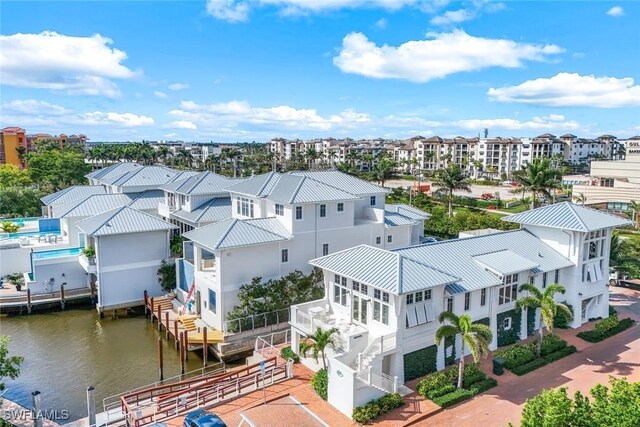 drone / aerial view featuring a residential view and a water view