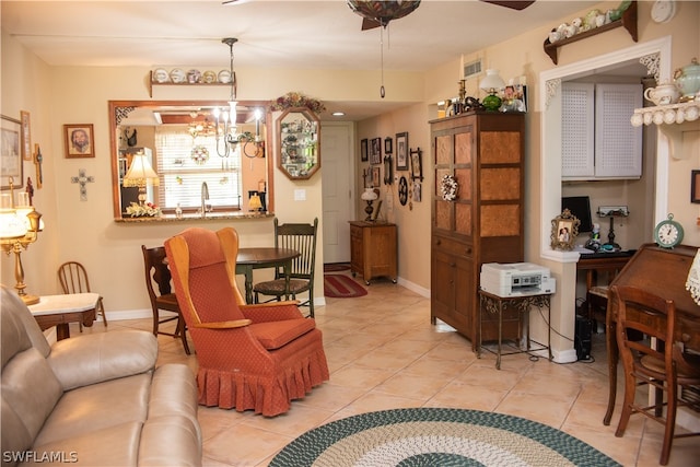 living room with ceiling fan with notable chandelier and light tile patterned floors