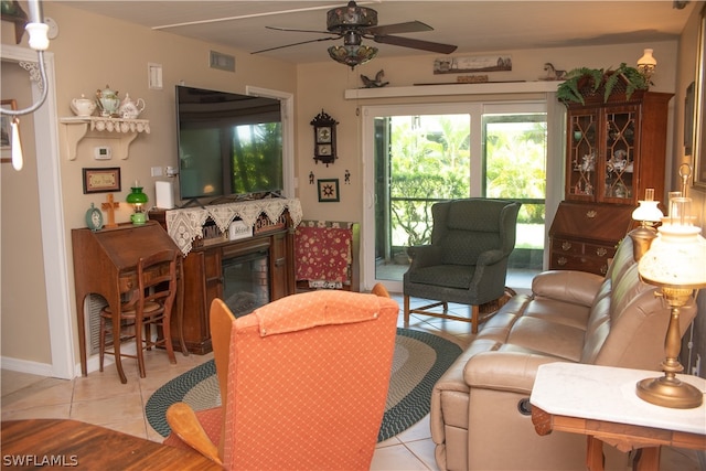 living room featuring light tile patterned floors and ceiling fan