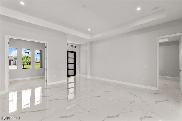 empty room featuring a raised ceiling