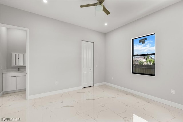 unfurnished bedroom with ceiling fan, a closet, and sink