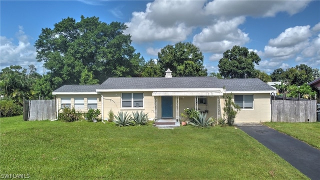 ranch-style home featuring a front yard