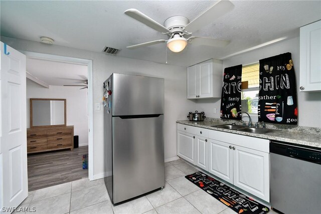 1235 Joerin Ave, North Fort Myers, FL 33903 - kitchen featuring ceiling fan, a sink, white cabinets, and appliances with stainless steel finishes