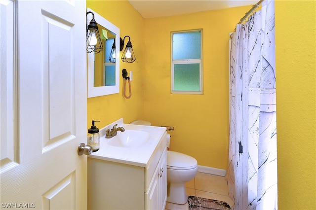 bathroom featuring tile patterned flooring, toilet, and vanity